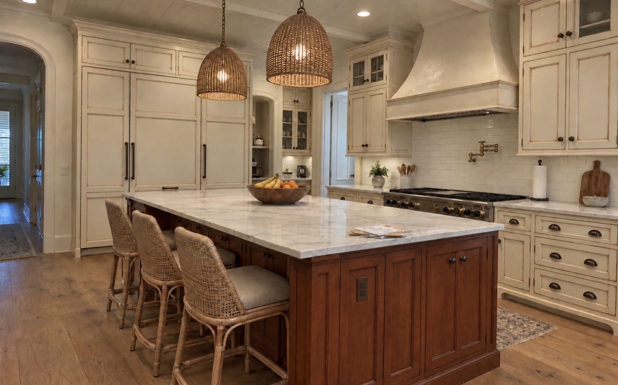 Kitchen in The Strand, Naples, FL before cabinet refinishing, with cream cabinets, a dark cherry wood island, and a marble countertop