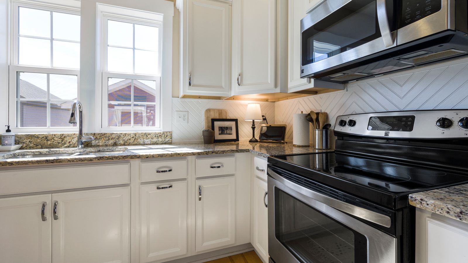 Freshly painted white kitchen cabinets in a bright, modern kitchen