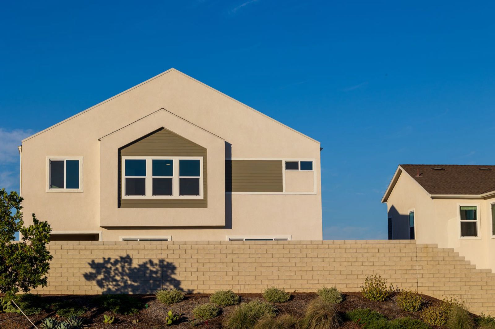 Sunlit exterior of a Southwest Florida home with freshly painted stucco siding